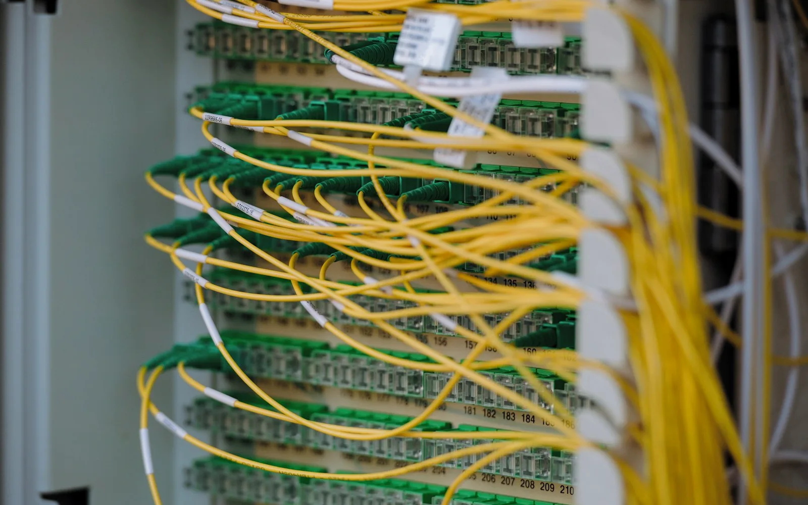 Permutatore ottico con cavi in fibra gialli collegati a connettori verdi.